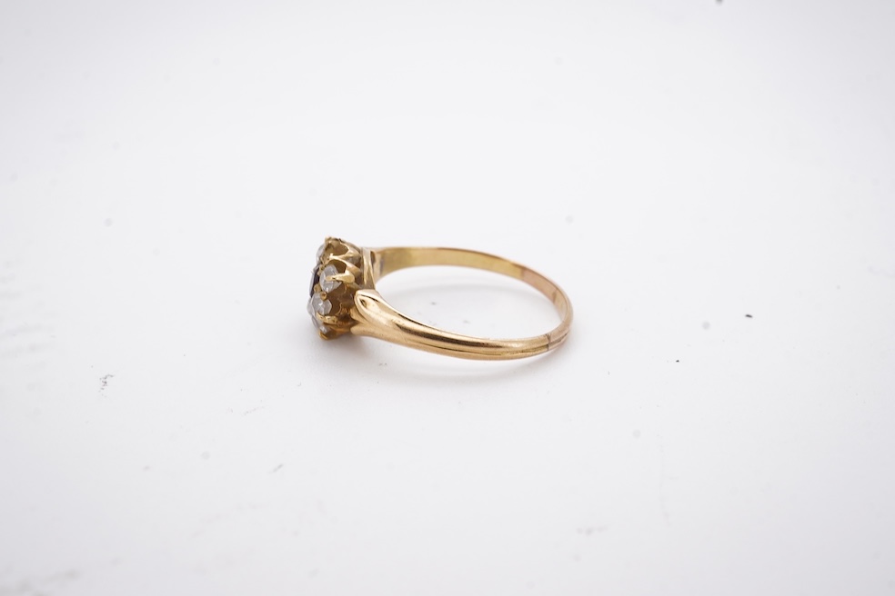A yellow metal, garnet? and diamond set circular cluster ring (one stone missing), size P, gross weight 3 grams. Condition - poor